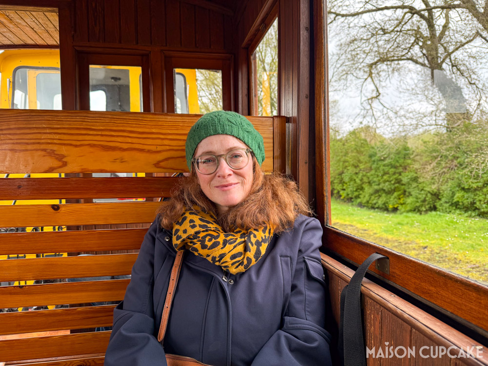 Sarah Trivuncic sat in wooden carriage of the Chemin de Fer de Somme, heritage railway in northern France.
