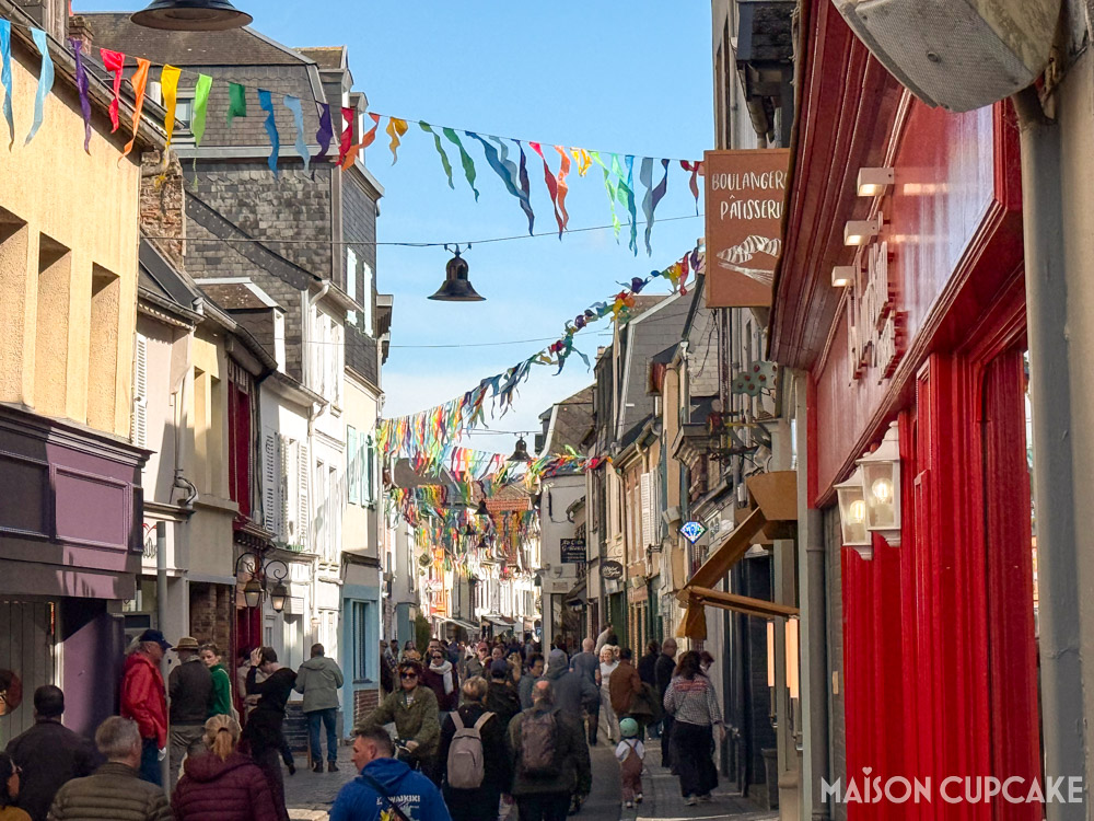Busy shopping street with bunting in Saint-Valery-sur-Somme