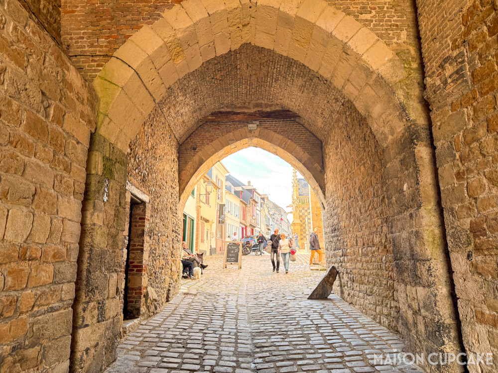 Medieval stone archway with cobbled street in Saint-Valery-sur-Somme, northern France