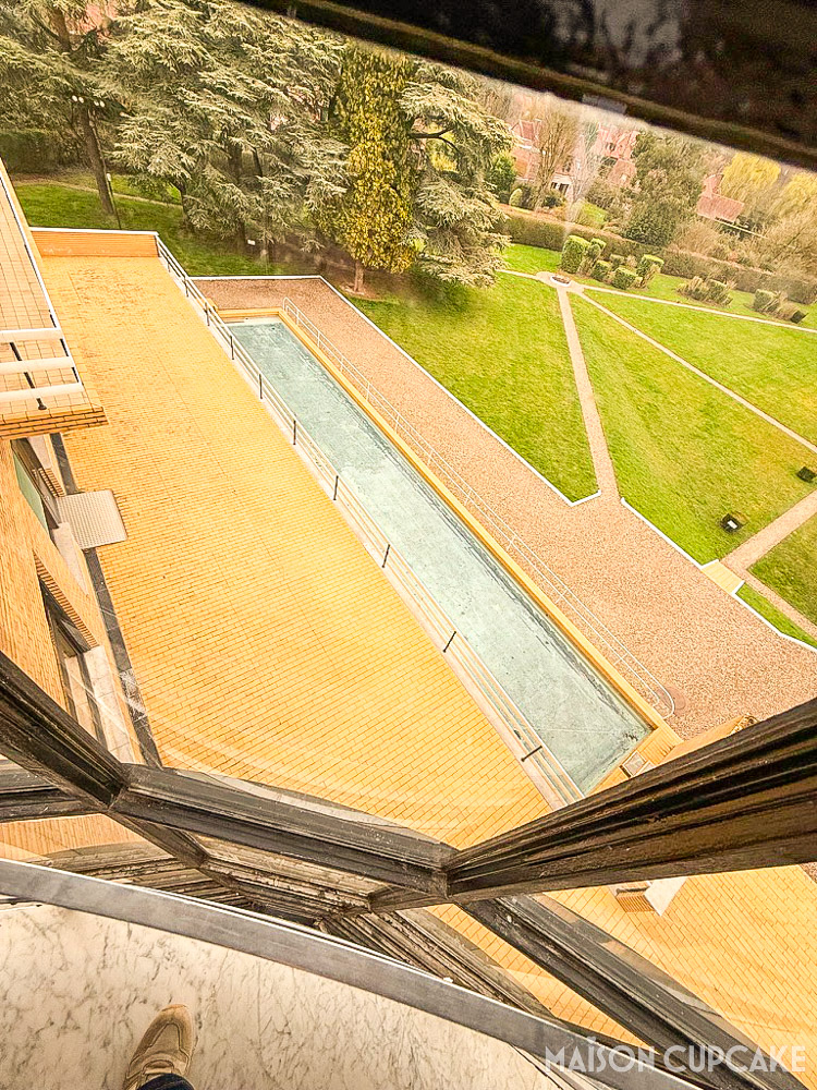 View from stairwell at Villa Cavrois modernist house looking down at pool and gardens